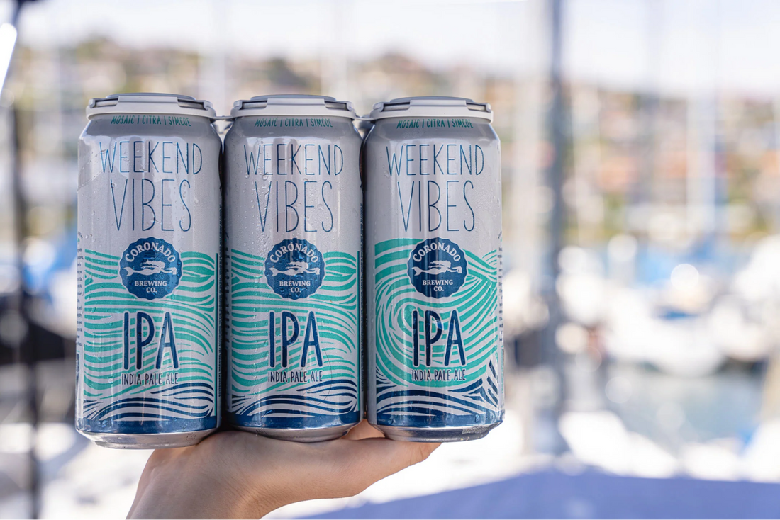 Three Weekend Vibes IPA cans by Coronado Brewing at a marina