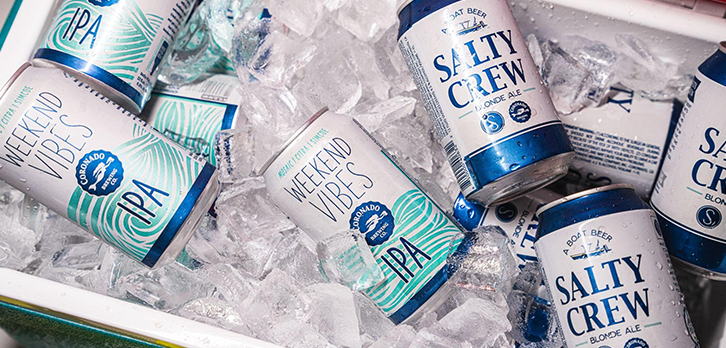 Coronado Brewing Weekend Vibes IPA and Salty Crew Blonde Ale chilling in a cooler packed with ice—ready for quick cooling