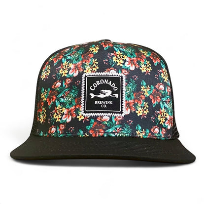Floral-patterned cap with Coronado Brewing Co. logo on a white background