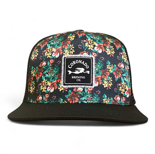 Floral-patterned cap with Coronado Brewing Co. logo on a white background